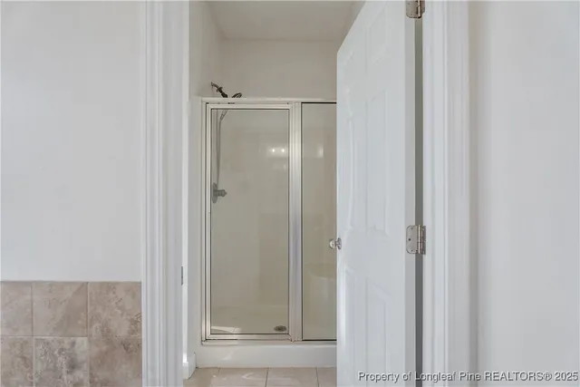 a bathroom with a glass shower door