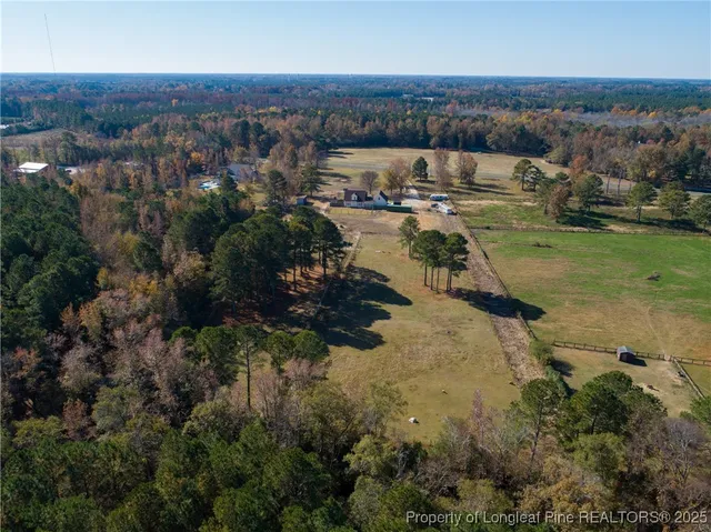 an aerial view of a house with yard
