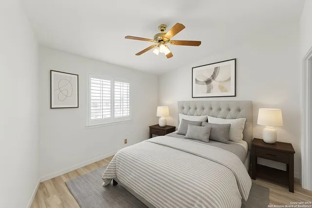 a bedroom with a bed and a painting on the wall