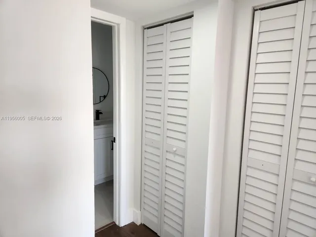 a view of walk in closet with clothes
