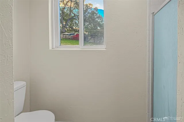 a white toilet sitting next to a window