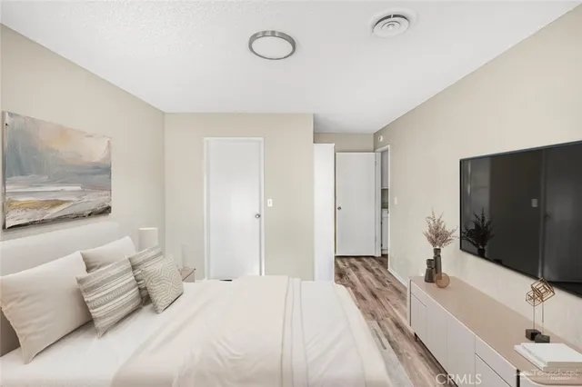 a spacious bedroom with a bed and a large mirror