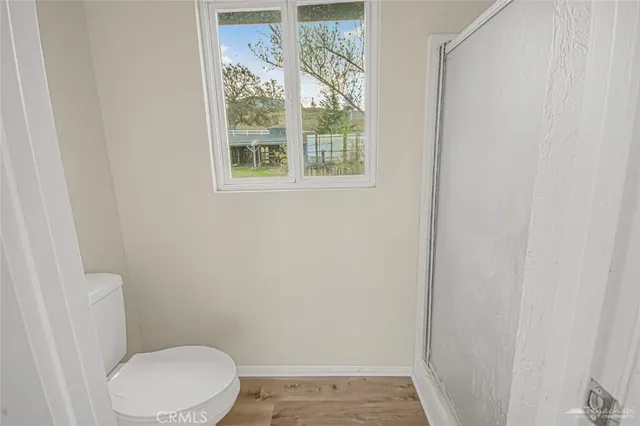 a white toilet sitting next to a window