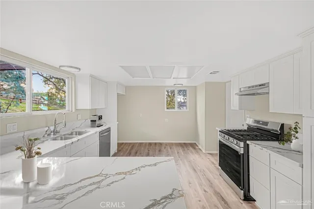 a kitchen with a stove a sink and a refrigerator