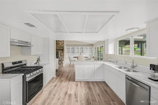 a kitchen with a sink stove and cabinets