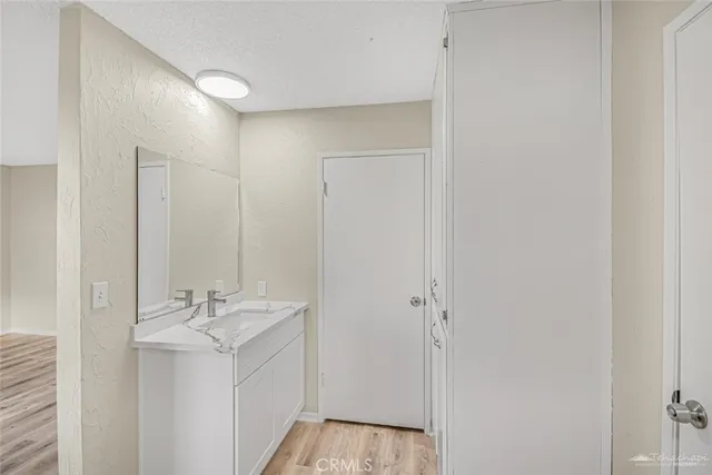 a bathroom with a sink a mirror and a shower
