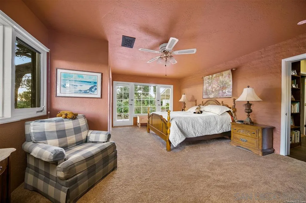 15738 Vesper Road Valley Center, CA 92082 - Photo 13 of 25 a spacious bedroom with a bed couch and window