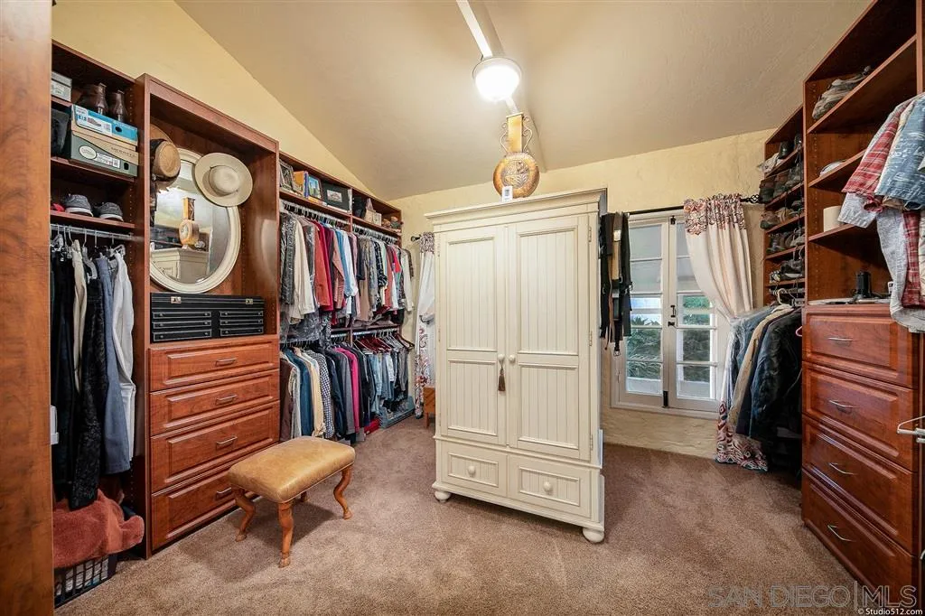 15738 Vesper Road Valley Center, CA 92082 - Photo 15 of 25 a view of walk in closet with clothes and shoes
