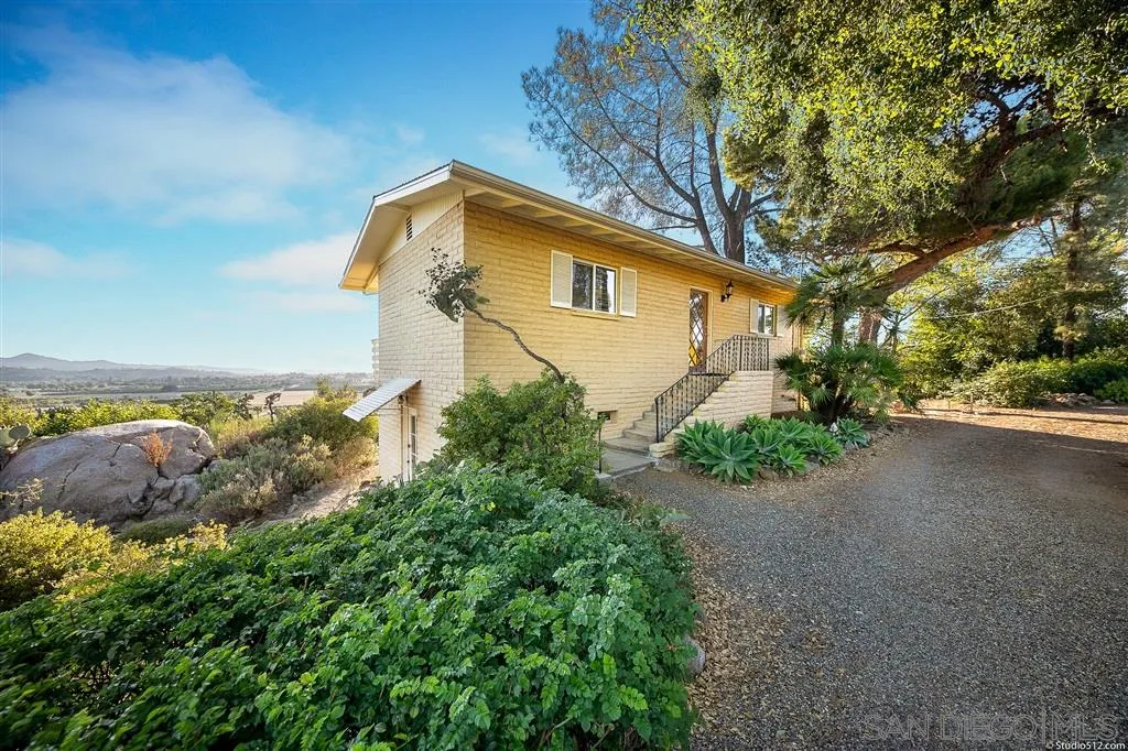 15738 Vesper Road Valley Center, CA 92082 - Photo 18 of 25 a backyard of a house with lots of green space
