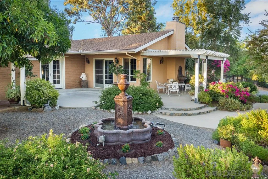 15738 Vesper Road Valley Center, CA 92082 - Photo 4 of 25 a front view of a house with garden and porch