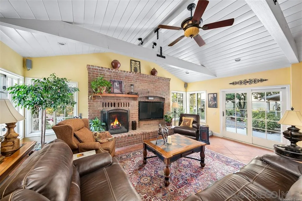 15738 Vesper Road Valley Center, CA 92082 - Photo 6 of 25 a living room with furniture a fireplace and a potted plant