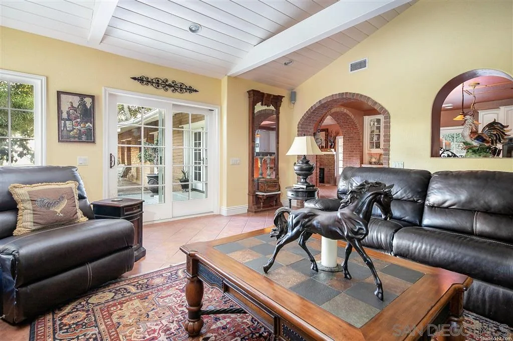 15738 Vesper Road Valley Center, CA 92082 - Photo 7 of 25 a living room with couches a coffee table and kitchen view with wooden floor