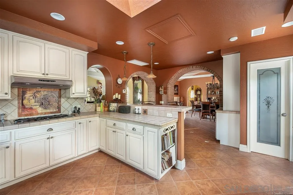 15738 Vesper Road Valley Center, CA 92082 - Photo 10 of 25 a large kitchen with cabinets and a sink