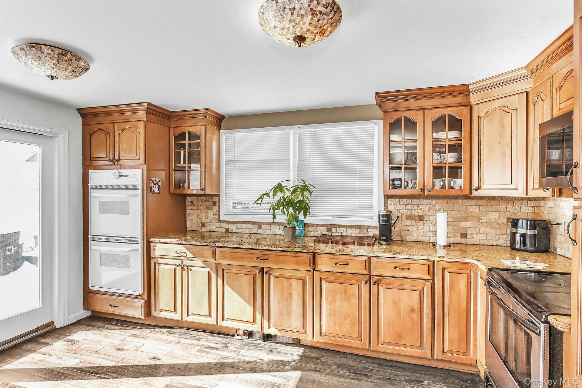 3348 3rd Street Oceanside, NY 11572 - Photo 12 of 32 a kitchen with stainless steel appliances granite countertop a refrigerator and a sink