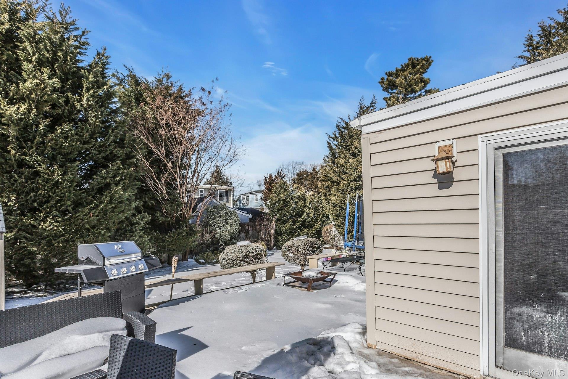 3348 3rd Street Oceanside, NY 11572 - Photo 20 of 32 a view of a patio with a table and chairs and potted plants