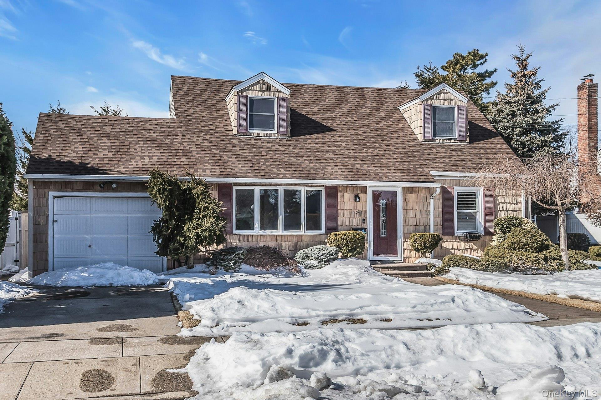 3348 3rd Street Oceanside, NY 11572 - Photo 2 of 32 a front view of a house with yard porch and glass outdoor space