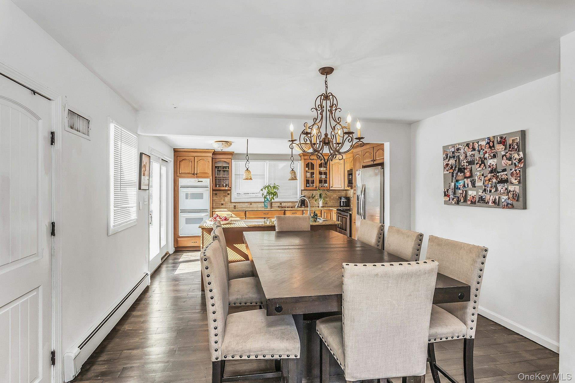 3348 3rd Street Oceanside, NY 11572 - Photo 23 of 32 a view of a dining room with furniture a chandelier and wooden floor