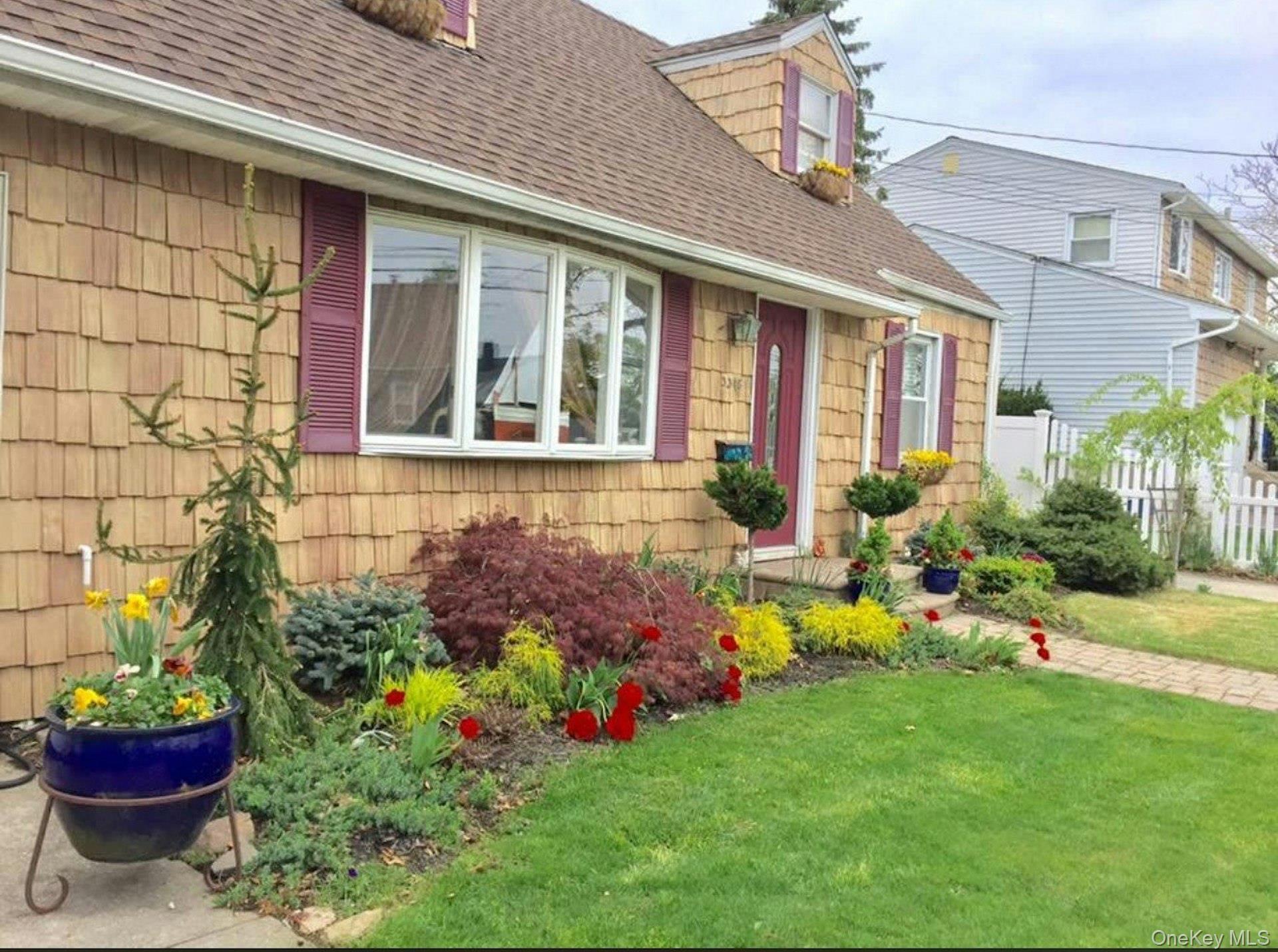 3348 3rd Street Oceanside, NY 11572 - Photo 32 of 32 a view of a house with a backyard and a garden