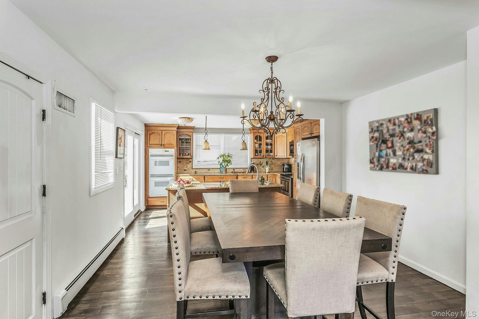 3348 3rd Street Oceanside, NY 11572 - Photo 7 of 32 a view of a dining room with furniture a chandelier and wooden floor