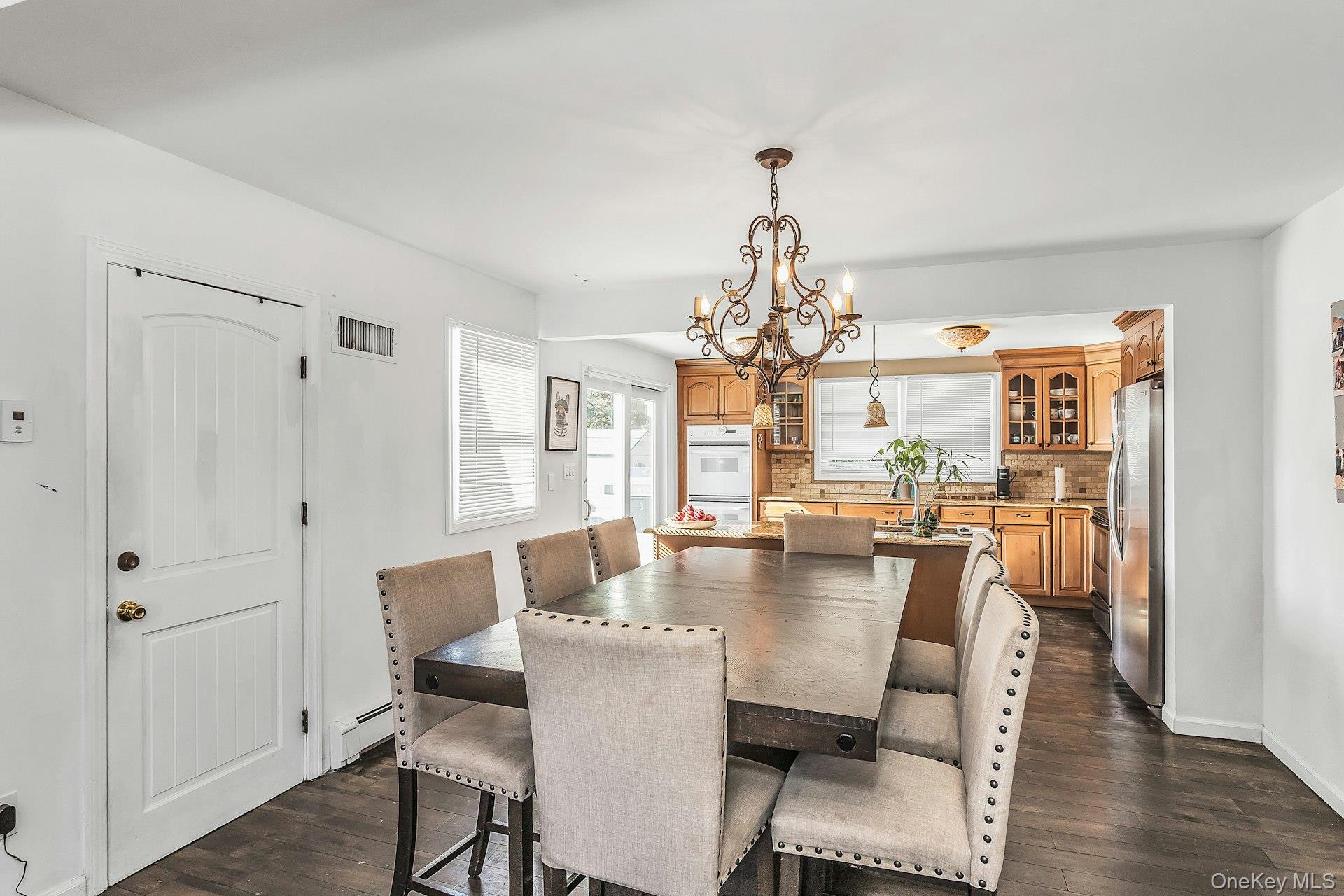 3348 3rd Street Oceanside, NY 11572 - Photo 8 of 32 a view of a dining room with furniture wooden floor and chandelier
