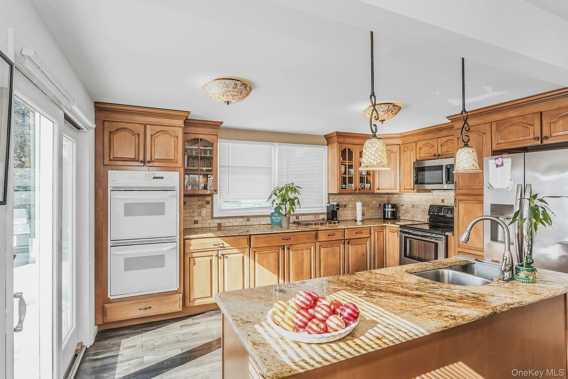 3348 3rd Street Oceanside, NY 11572 - Photo 9 of 32 a kitchen with a refrigerator stove and sink
