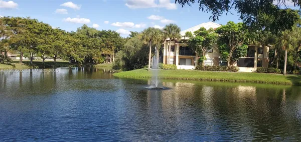 a view of a lake with a house in the background