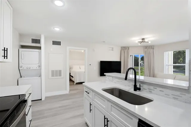 a kitchen with a refrigerator and a sink