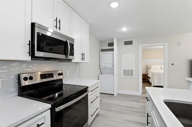a kitchen with stainless steel appliances a stove microwave and refrigerator