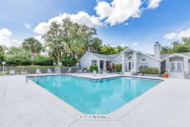 a view of pool and trees in the background