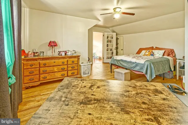 a spacious bedroom with a bed and a dresser