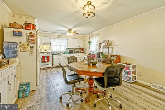 a view of a dining room with furniture and wooden floor