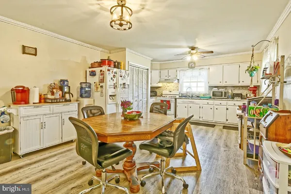 a kitchen with stainless steel appliances granite countertop a sink dishwasher and cabinets with wooden floor
