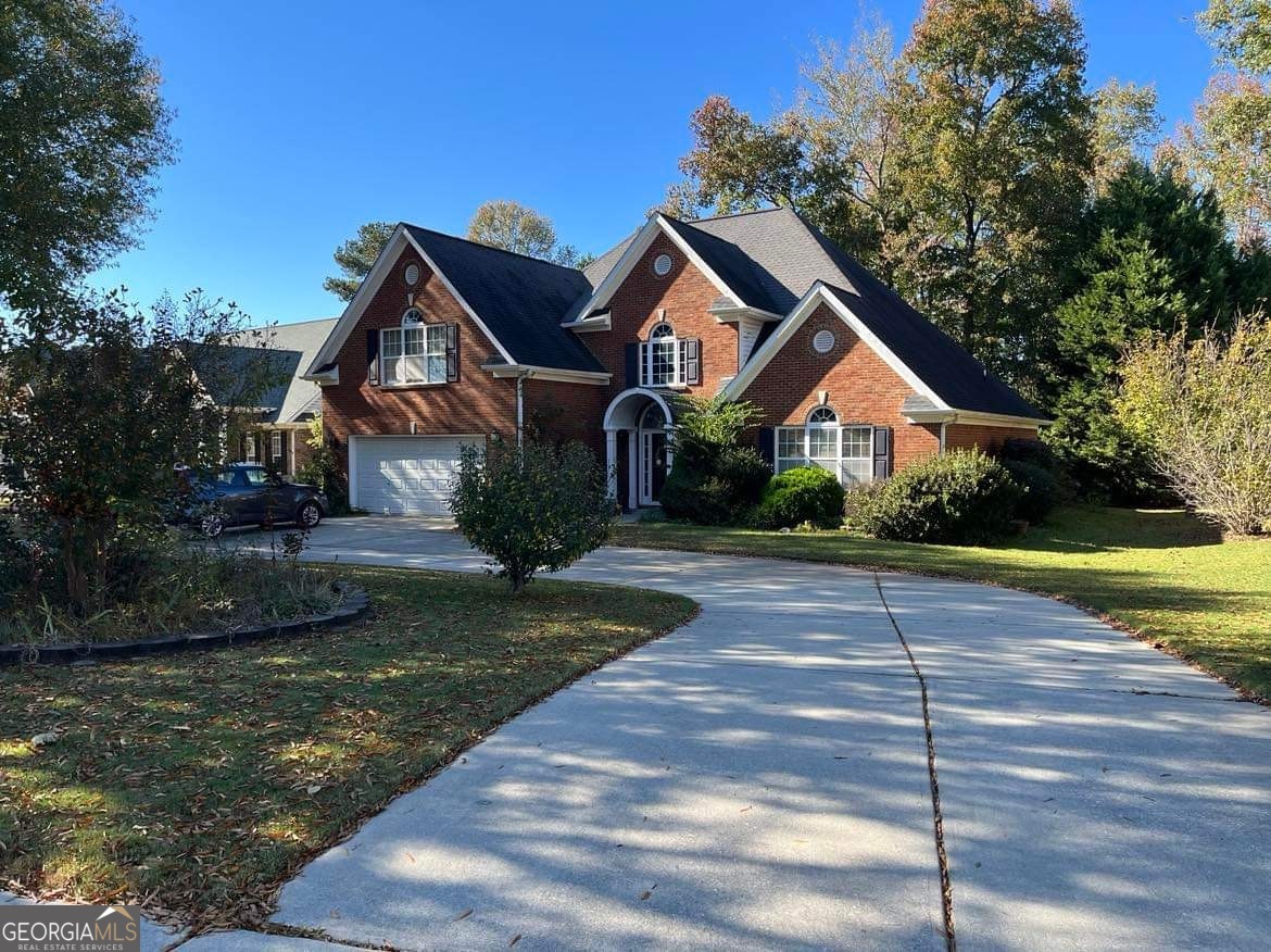 a front view of a house with yard