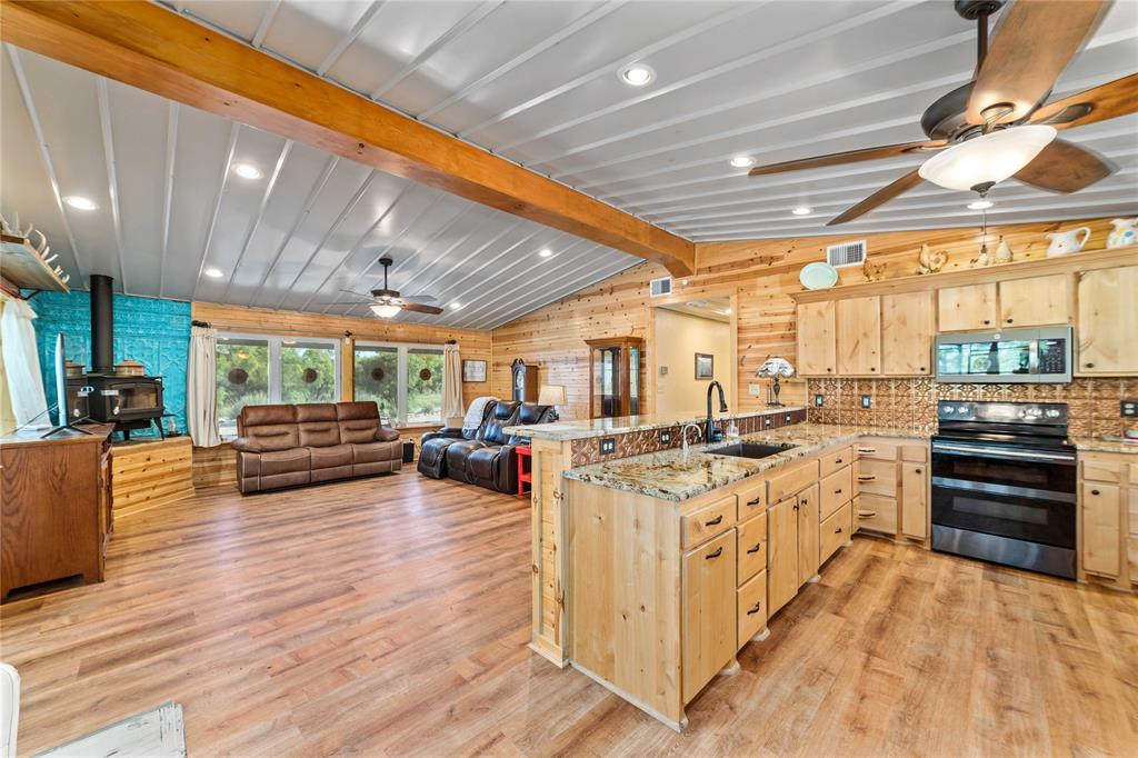970 County Road 256 Coleman, TX 76834 - Photo 12 of 35 a kitchen with lots of counter top space and wooden floor