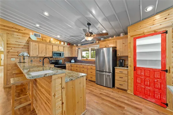 a large white kitchen with a large window