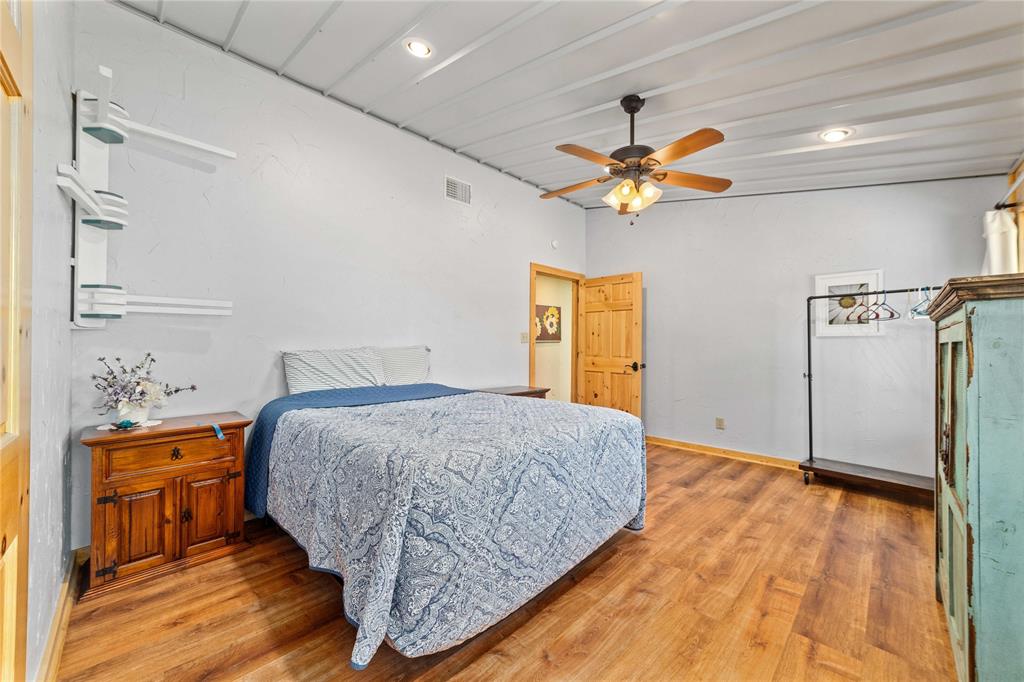 970 County Road 256 Coleman, TX 76834 - Photo 20 of 35 a bedroom with a bed and a chandelier