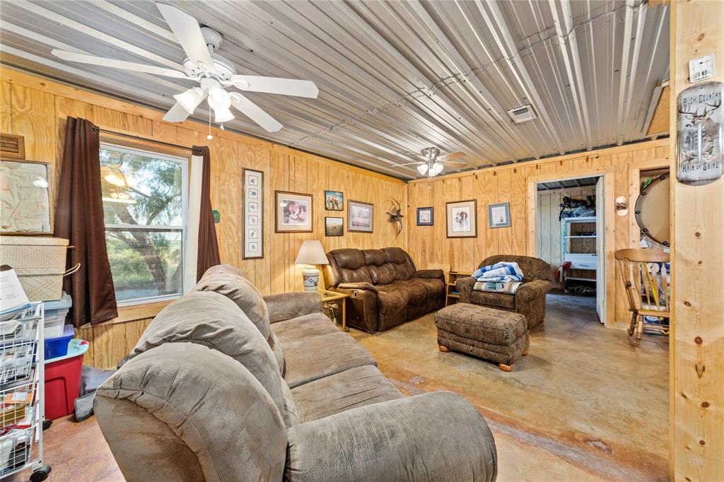 970 County Road 256 Coleman, TX 76834 - Photo 29 of 35 a living room with furniture a chandelier and a large window