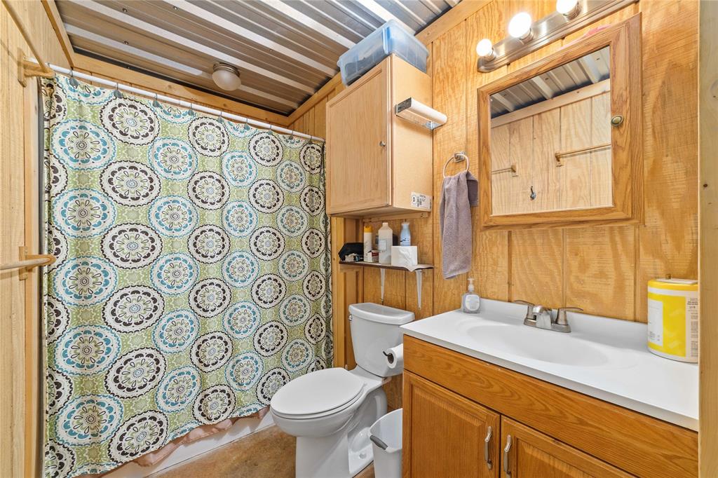 970 County Road 256 Coleman, TX 76834 - Photo 35 of 35 a bathroom with a sink and mirror with toilet