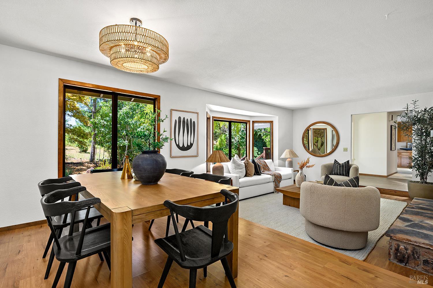 7595 Giusti Road Forestville, CA 95436 - Photo 9 of 41 a view of a dining room with furniture a chandelier and wooden floor