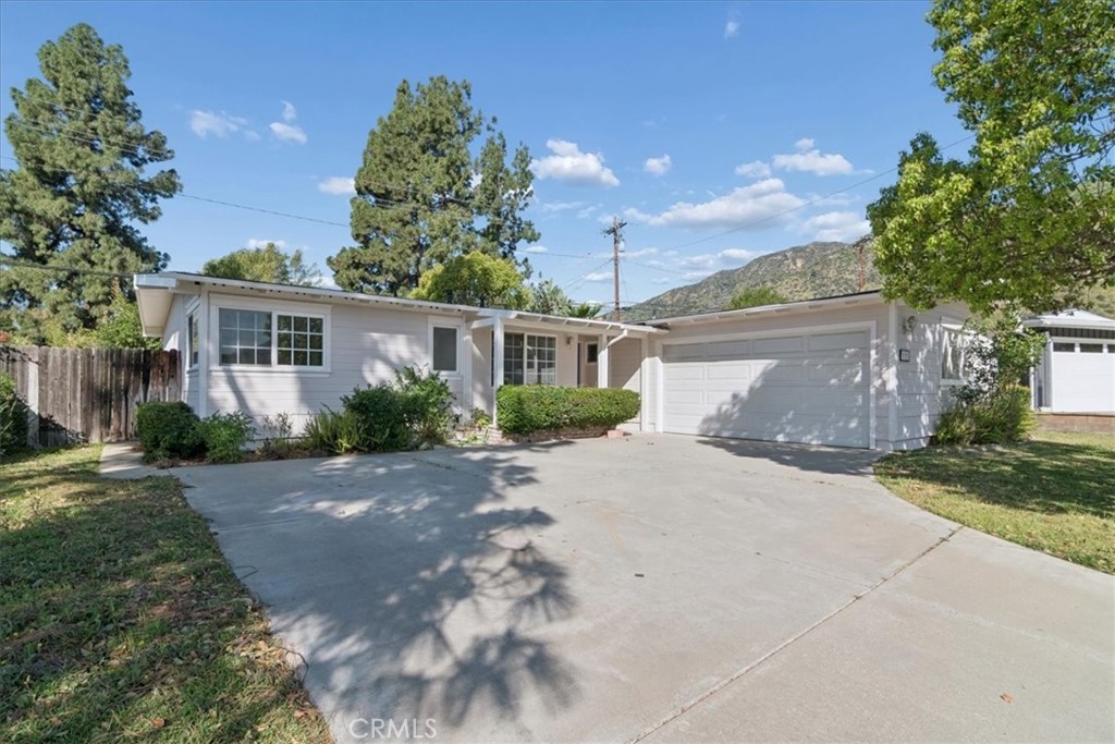 3093 Fish Canyon Road Duarte, CA 91010 - Photo 1 of 27 a front view of a house with a yard and a garage