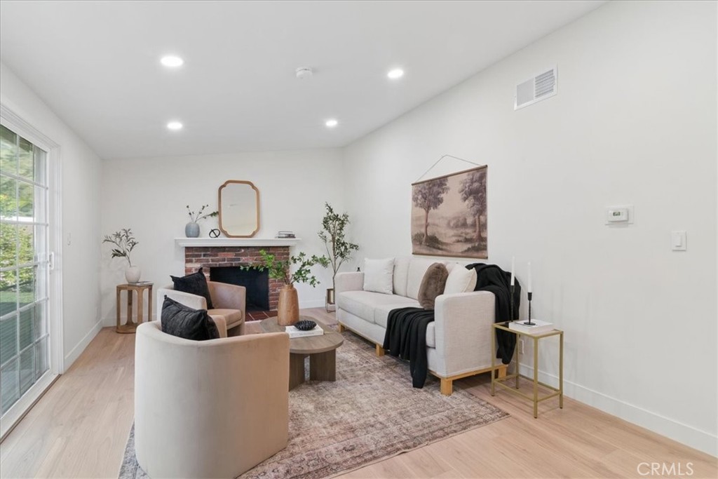 3093 Fish Canyon Road Duarte, CA 91010 - Photo 9 of 27 a living room with furniture a fireplace and potted plants
