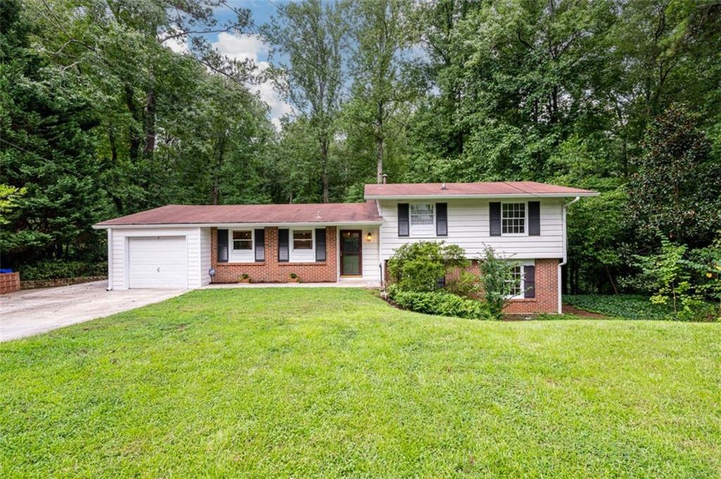 1471 Bubbling Creek Road Northeast Brookhaven, GA 30319 - Photo 1 of 1 a front view of a house with a yard and trees