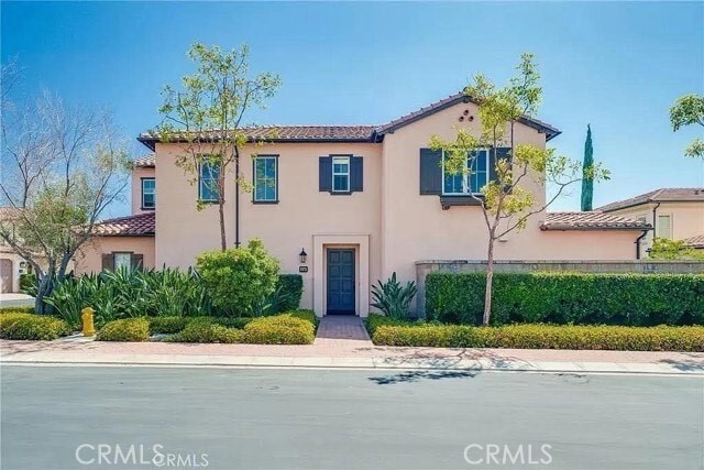 216 Midvale Irvine, CA 92620 - Photo 1 of 9 a front view of a house with a yard and garage
