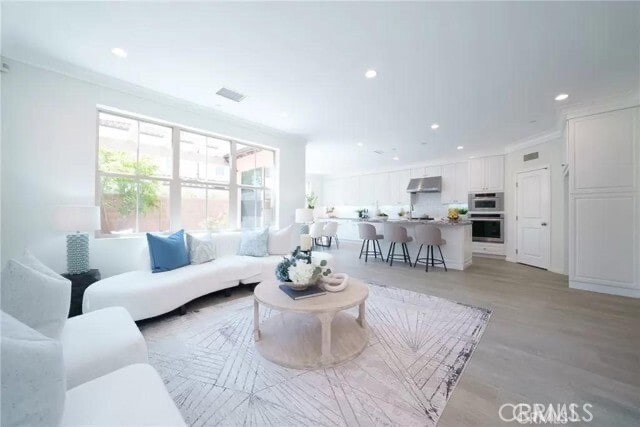 216 Midvale Irvine, CA 92620 - Photo 5 of 9 a living room with furniture and a large window