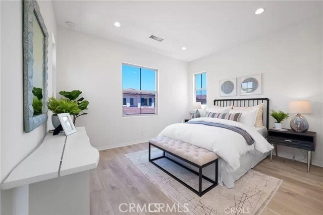 216 Midvale Irvine, CA 92620 - Photo 6 of 9 a bedroom with a bed and a potted plant