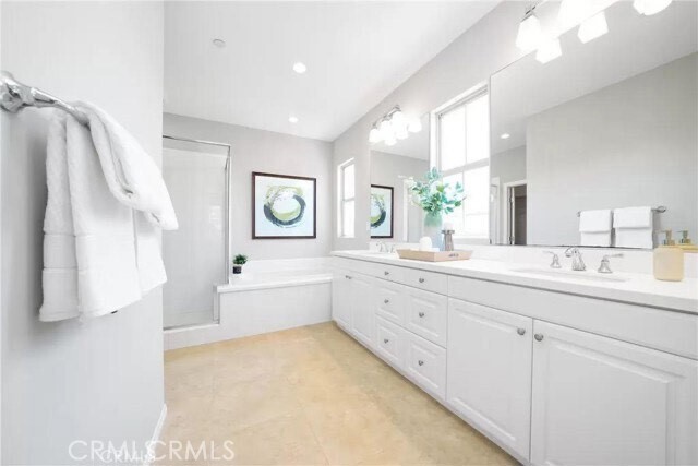 216 Midvale Irvine, CA 92620 - Photo 7 of 9 a large bathroom with a granite countertop sink mirror and a bathtub