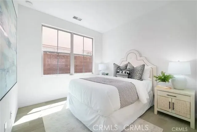 a bedroom with a large bed and a window