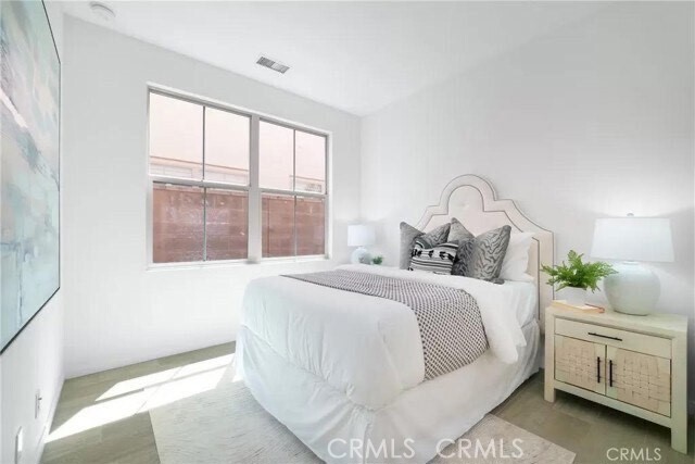 216 Midvale Irvine, CA 92620 - Photo 8 of 9 a bedroom with a large bed and a window