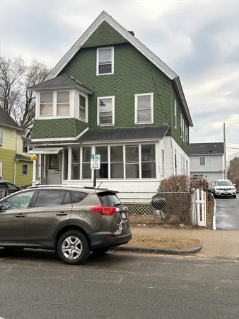 a front view of a house with parking space
