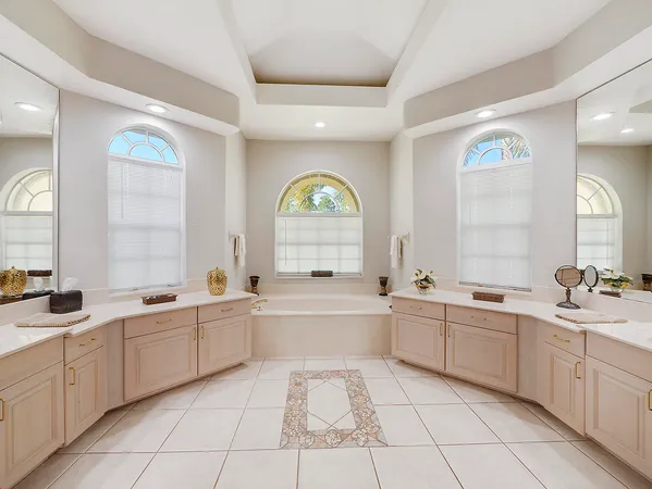 a large kitchen with a lot of white cabinets